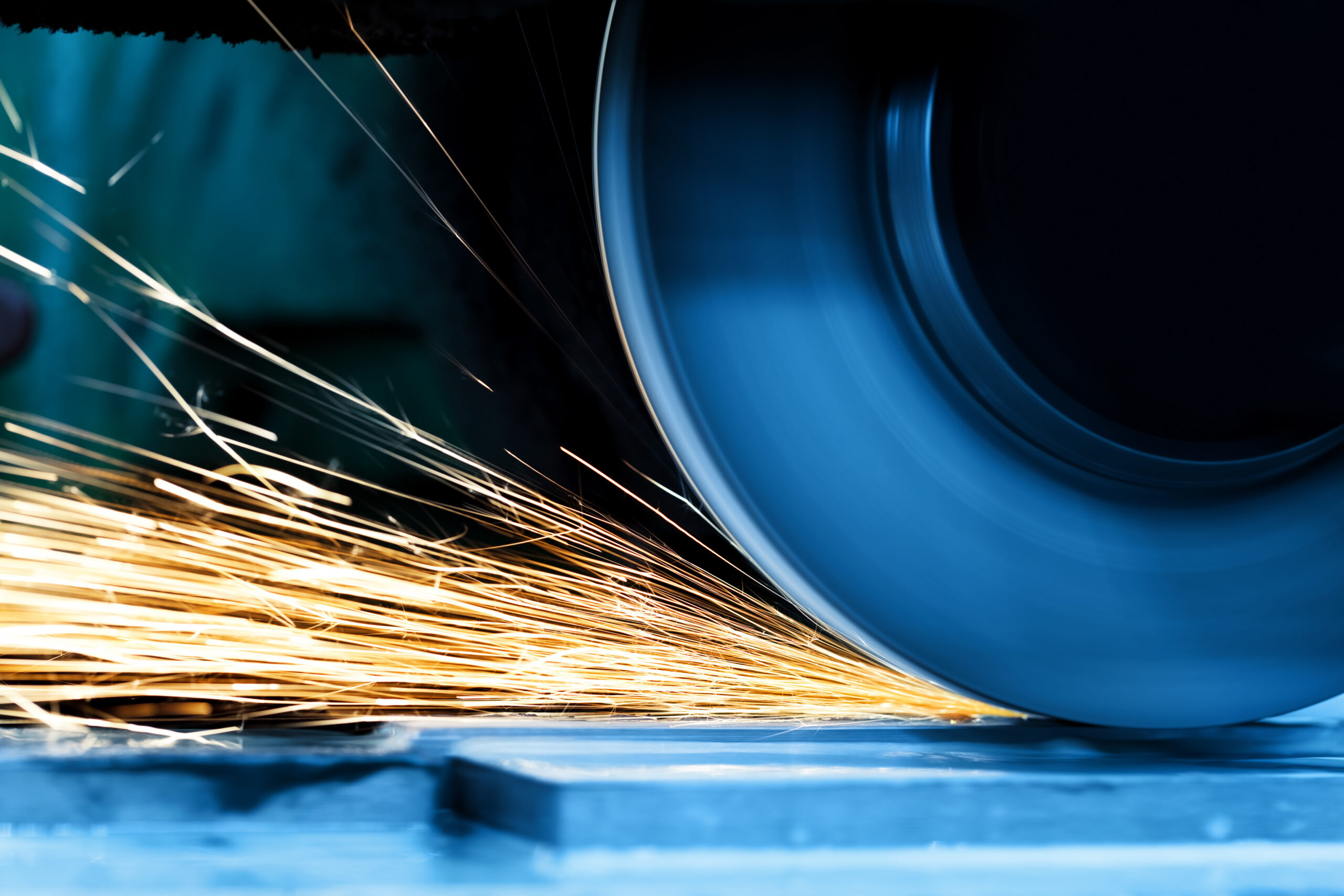 Sparks from grinding machine in workshop. Industrial background, industry.